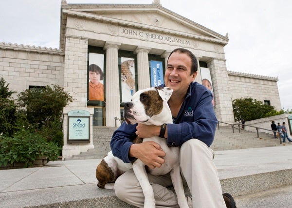 Ken Ramirez hugs dog on steps