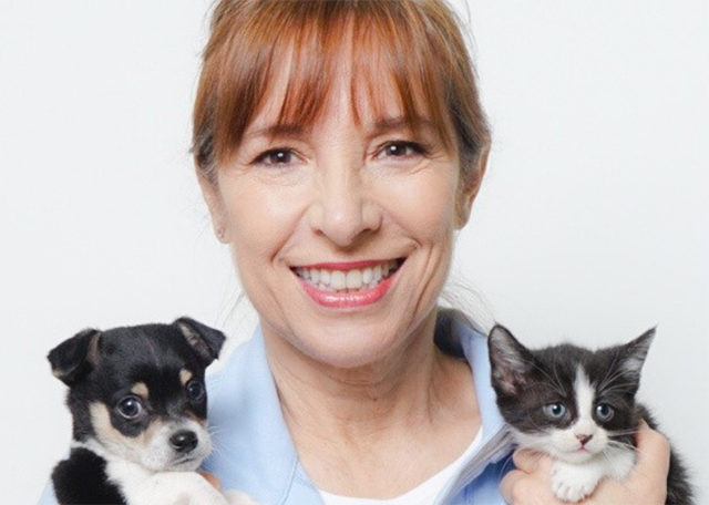 Photo of Sara Pizano holding a kitten and puppy