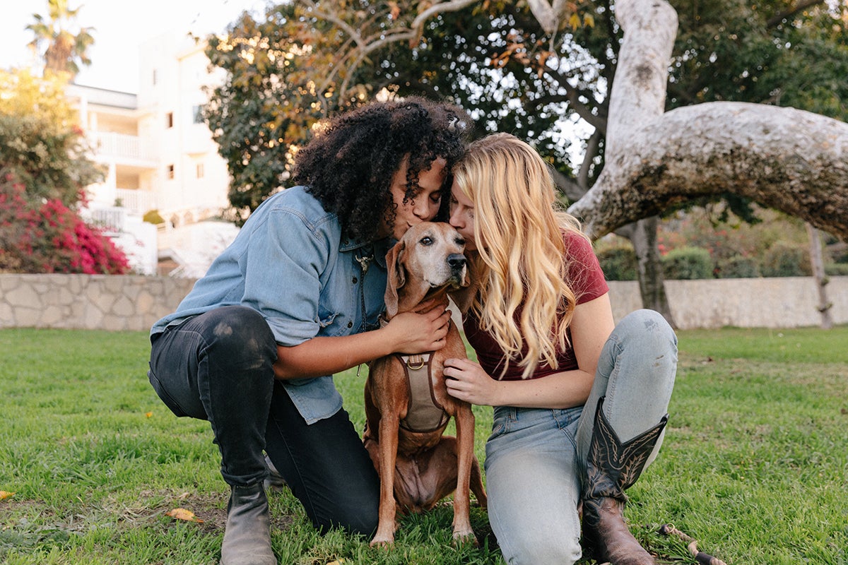 Couple hug and kiss pet dog