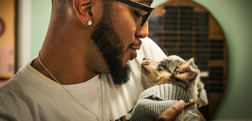 Elijah Brice-Middleton holds dog in his arms