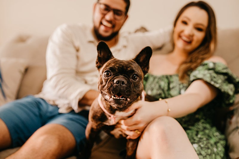Happy family hangs out with dog