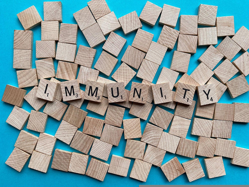 Scrabble tiles spell the word IMMUNITY
