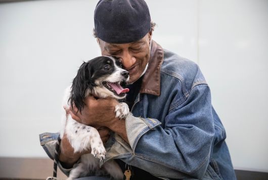 A man hugs his dog