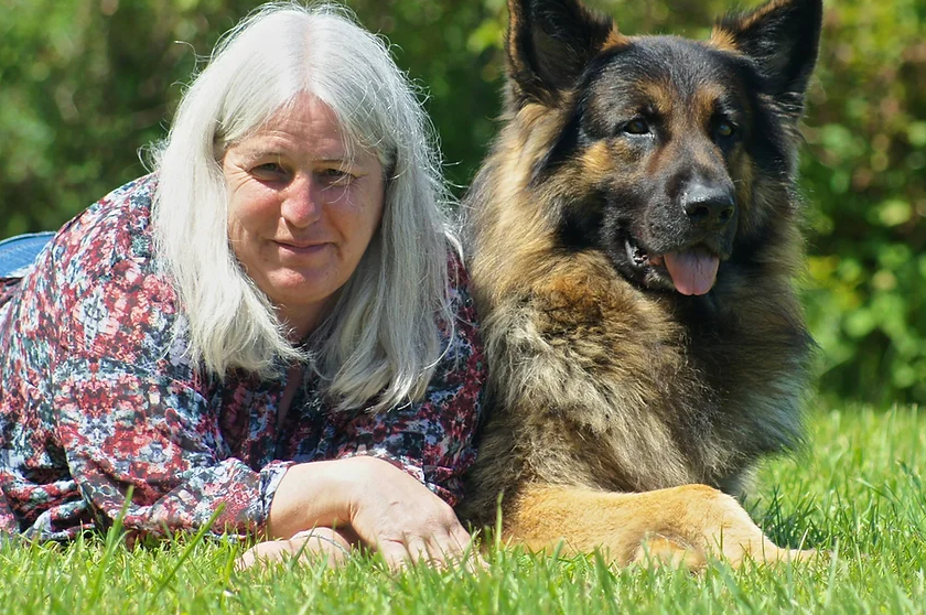 Suzannne Clothier poses next to a dog